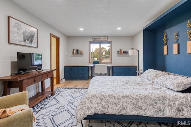 bedroom with light wood finished floors, a desk, and recessed lighting