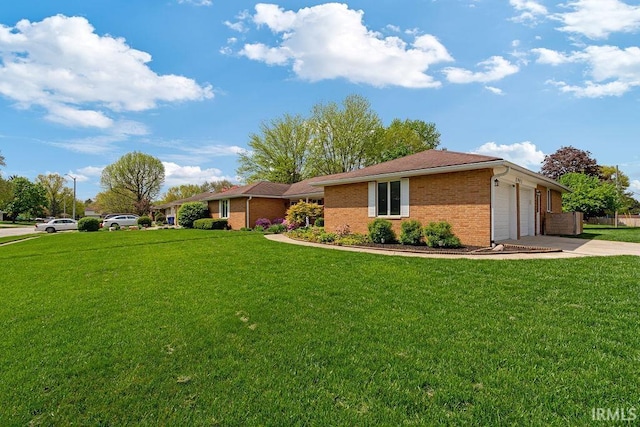 ranch-style house with concrete driveway, brick siding, a front lawn, and an attached garage