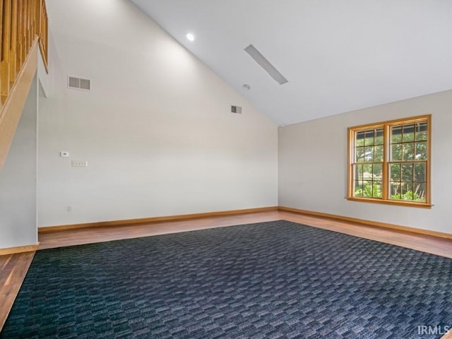 unfurnished room with wood finished floors, high vaulted ceiling, recessed lighting, and baseboards