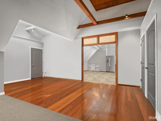 additional living space with wood finished floors and baseboards