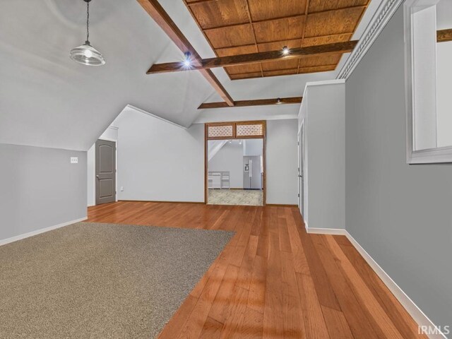 bonus room with hardwood / wood-style floors and baseboards