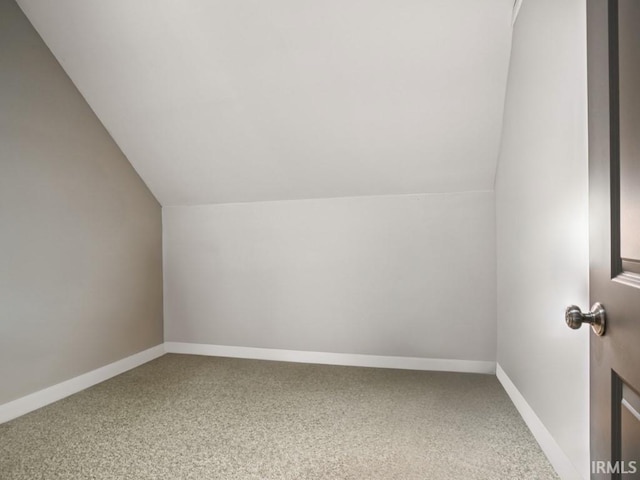 bonus room featuring vaulted ceiling, carpet floors, and baseboards