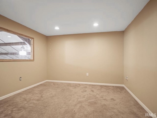 carpeted spare room featuring baseboards and recessed lighting