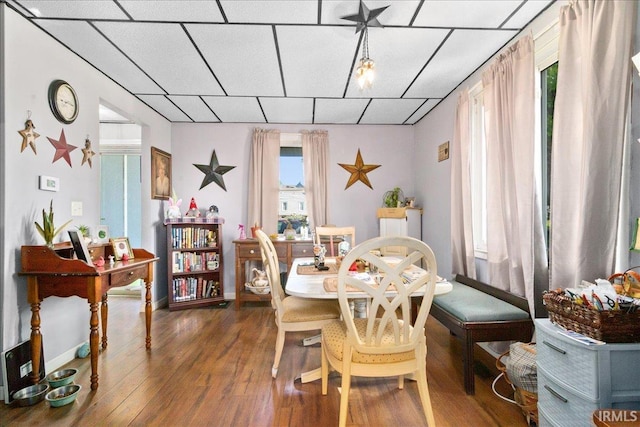 510 W Washington St, Oakland City, IN 47660 - dining area featuring a paneled ceiling, wood-type flooring, and baseboards