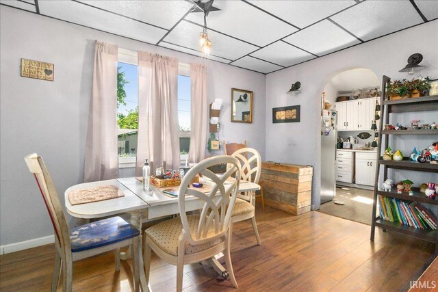 510 W Washington St, Oakland City, IN 47660 - dining space with wood finished floors, arched walkways, and a drop ceiling