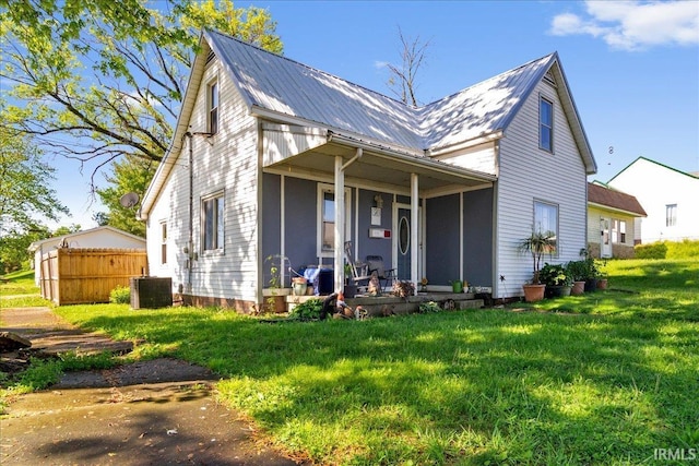 510 W Washington St, Oakland City, IN 47660 - view of front of home featuring covered porch, central AC, and metal roof