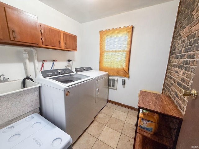 clothes washing area featuring separate washer and dryer, cabinet space, and light tile patterned floors
