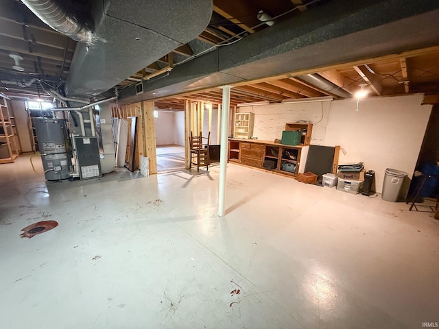 unfinished below grade area with water heater and heating unit