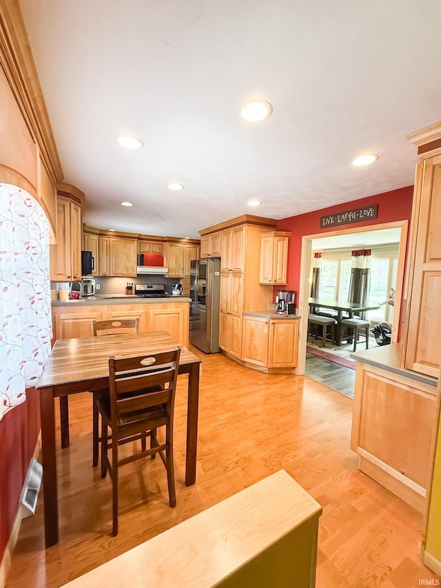 kitchen featuring appliances with stainless steel finishes, light wood-type flooring, recessed lighting, and light brown cabinetry