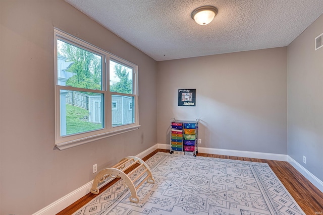 623 Forest Park Dr, Newburgh, IN 47630 - rec room featuring wood finished floors, a textured ceiling, and baseboards