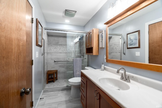 full bath with a shower stall, toilet, and vanity