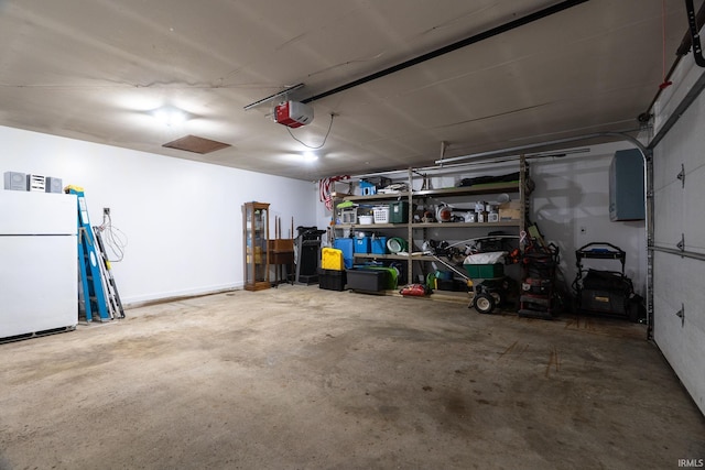 garage with freestanding refrigerator and a garage door opener