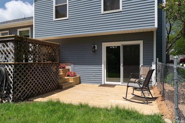 wooden terrace featuring fence
