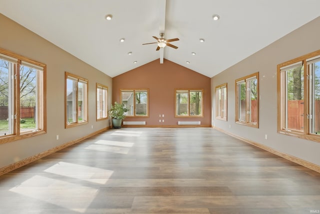 unfurnished living room featuring wood finished floors, beam ceiling, a ceiling fan, high vaulted ceiling, and baseboards