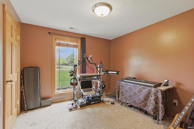 exercise room featuring carpet flooring and baseboards