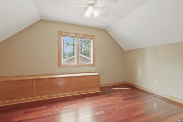 bonus room featuring vaulted ceiling, wood finished floors, ceiling fan, and baseboards