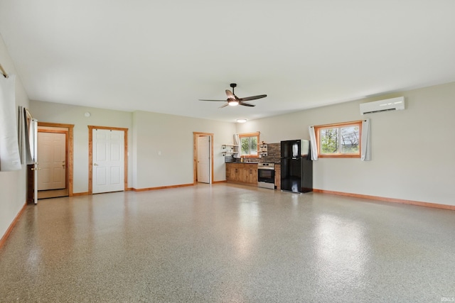 unfurnished living room with a wall mounted AC, baseboards, and a ceiling fan