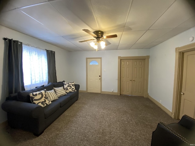 living area with ceiling fan, carpet flooring, and baseboards