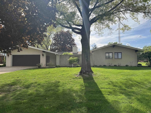 10059 Quince Rd, Plymouth, IN 46563 - view of front facade featuring brick siding, a garage, a front yard, driveway, and a chimney