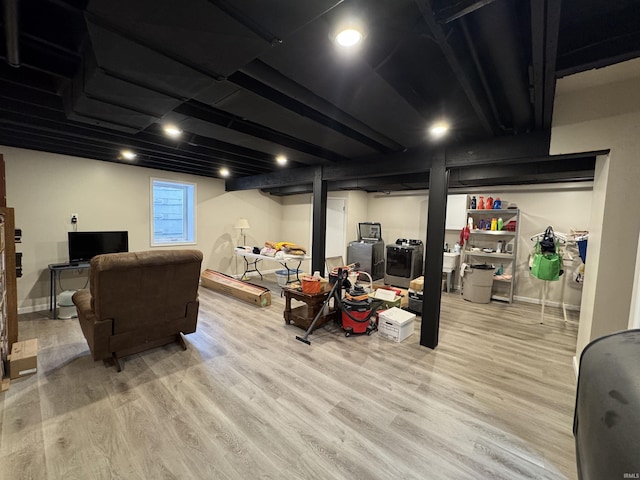 10059 Quince Rd, Plymouth, IN 46563 - basement with light wood-style floors, washer / clothes dryer, and baseboards