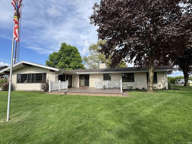 10059 Quince Rd, Plymouth, IN 46563 - back of house featuring brick siding, a deck, a yard, and a chimney