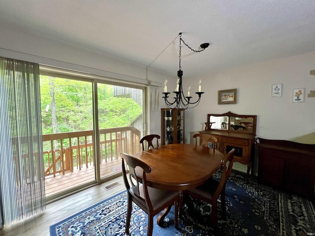 dining space featuring a chandelier and wood finished floors