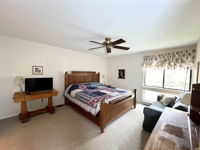 carpeted bedroom with ceiling fan and baseboards