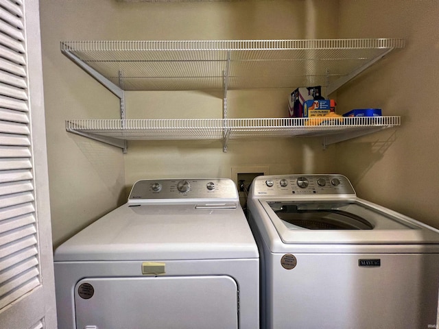 clothes washing area with separate washer and dryer