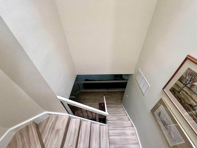 stairs featuring wood finished floors