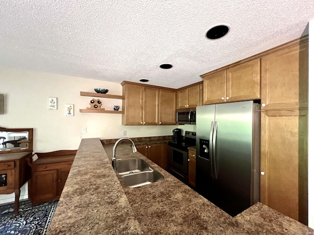 kitchen featuring stainless steel appliances, a sink, a textured ceiling, open shelves, and brown cabinetry