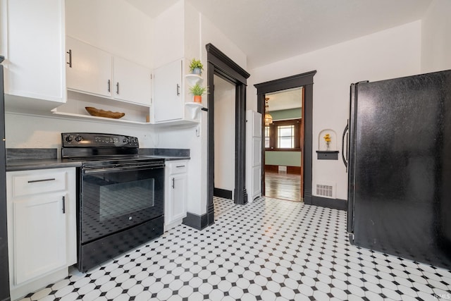 kitchen featuring black appliances, dark countertops, and white cabinetry