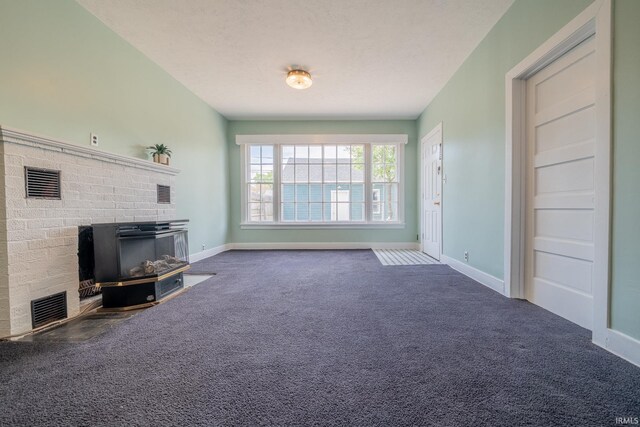 unfurnished living room featuring carpet floors, a fireplace, and baseboards