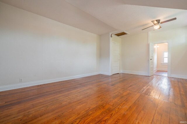 spare room featuring wood-type flooring, baseboards, and a ceiling fan
