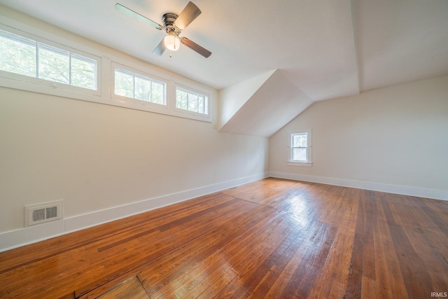 bonus room featuring baseboards, hardwood / wood-style flooring, a ceiling fan, and lofted ceiling