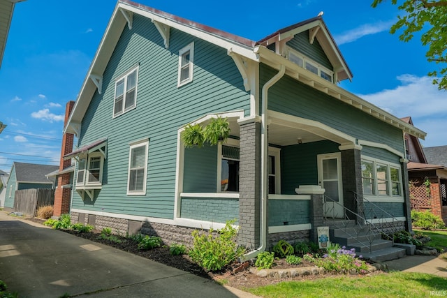 view of side of property with a porch