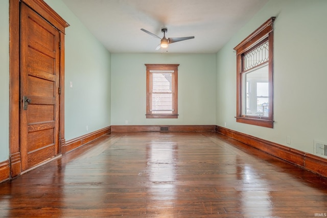 unfurnished room with hardwood / wood-style flooring, ceiling fan, and baseboards