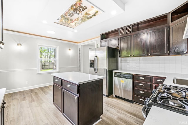 kitchen with stainless steel appliances, light countertops, decorative backsplash, light wood-type flooring, and recessed lighting