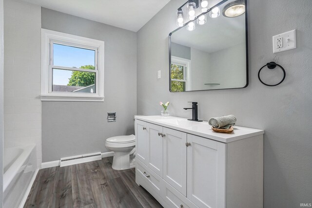 13840 Day Rd, Mishawaka, IN 46545 - full bathroom with a baseboard heating unit, toilet, healthy amount of natural light, and wood finished floors