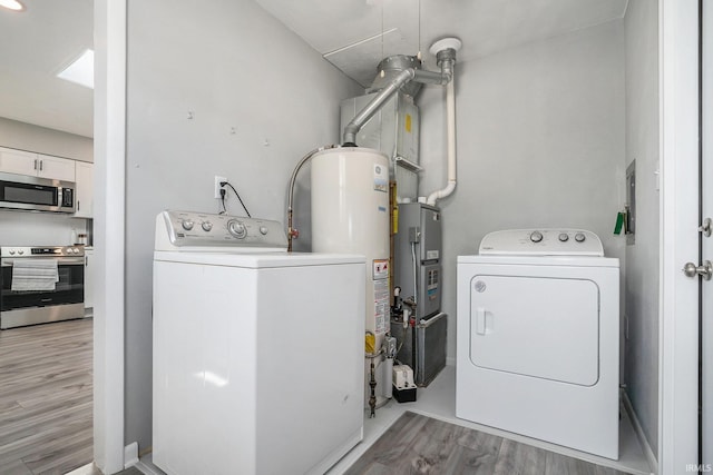 13840 Day Rd, Mishawaka, IN 46545 - washroom featuring washing machine and dryer, gas water heater, and light wood-style floors