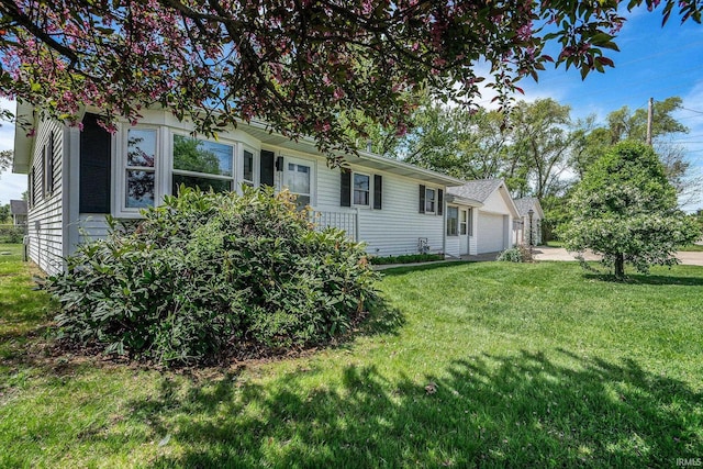 13840 Day Rd, Mishawaka, IN 46545 - view of front facade featuring a garage and a front lawn