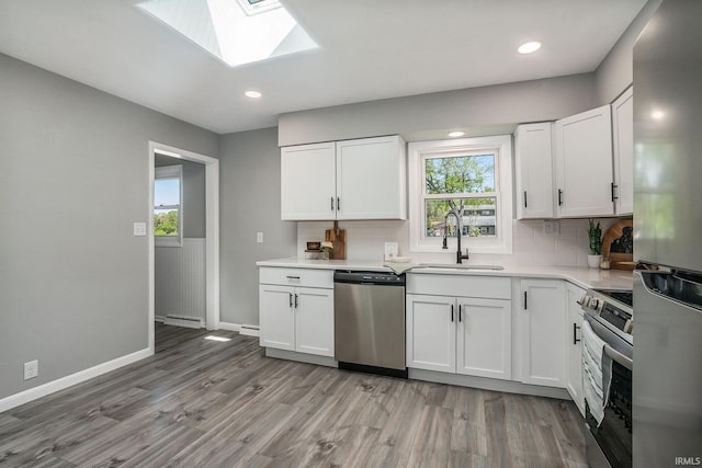 13840 Day Rd, Mishawaka, IN 46545 - kitchen with stainless steel appliances, a sink, backsplash, light wood-style floors, and recessed lighting