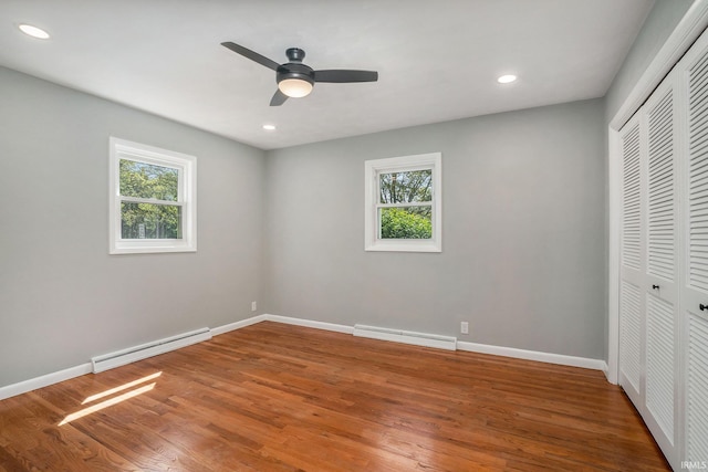 13840 Day Rd, Mishawaka, IN 46545 - unfurnished bedroom featuring a baseboard radiator, baseboard heating, a closet, wood finished floors, and recessed lighting