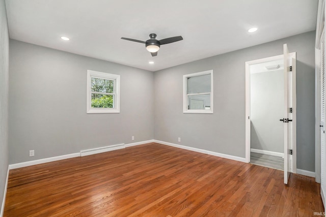 13840 Day Rd, Mishawaka, IN 46545 - empty room with a ceiling fan, a baseboard radiator, wood finished floors, baseboards, and recessed lighting