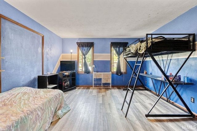bedroom featuring wood finished floors