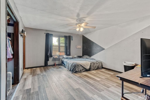 bedroom with wood finished floors, baseboards, and a ceiling fan