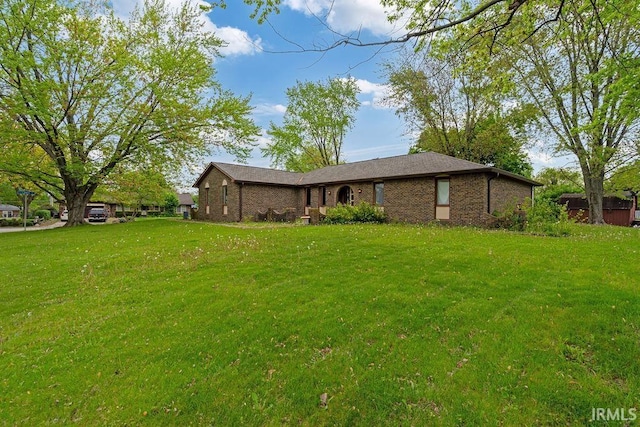 view of front of home featuring a front lawn and brick siding