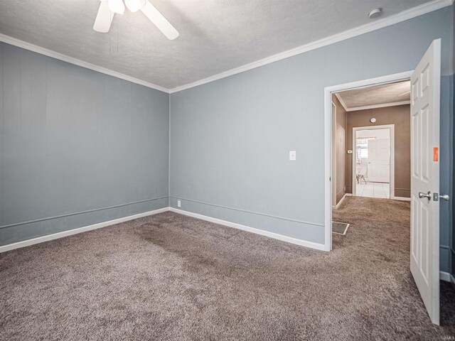 unfurnished room featuring carpet flooring, a ceiling fan, crown molding, a textured ceiling, and baseboards