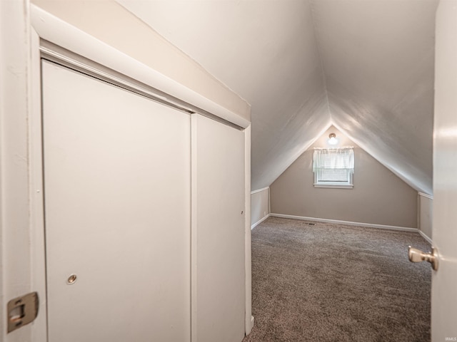 bonus room featuring vaulted ceiling and carpet
