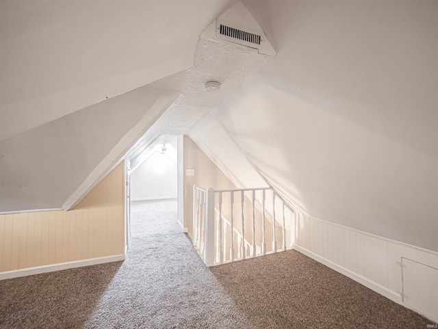bonus room with carpet and vaulted ceiling