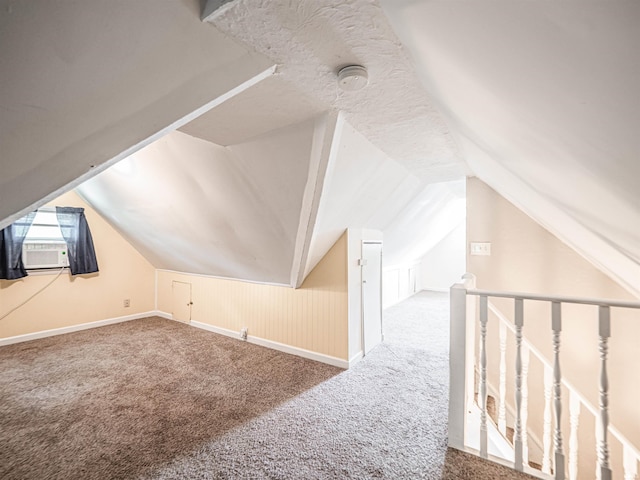 bonus room featuring carpet flooring, vaulted ceiling, baseboards, and cooling unit